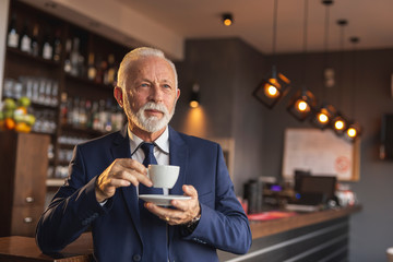 Senior businessman having a cup of coffee