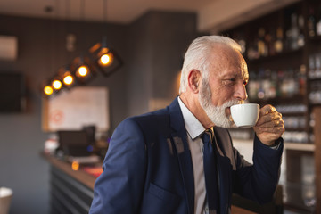 Senior businessman on a coffee break