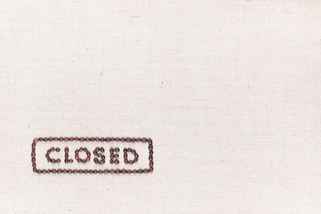The word Closed inside a rectangle written with coffee beans,aligned at the bottom left.
