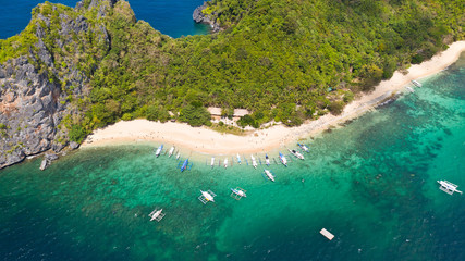 Tourists relax on the white beach of the island of Helikopter.Tropical white sand beach. Seascape with tropical islands. © Tatiana Nurieva