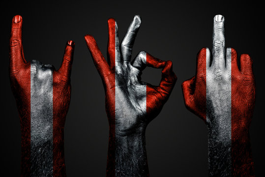 a set of three hands with a painted flag Austria show middle finger, goat and Okay, a sign of aggression, protest and approval on a dark background.