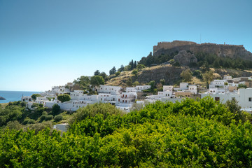 Fototapeta na wymiar Lindos ,Rhodes/Greece May 2 2019 : the most historic village of the island and the view of the acropolis and the white houses from the square