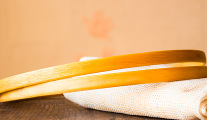 Wooden embroidery hoops  with white fabric for cross stitching on wooden table. Vintage styling.