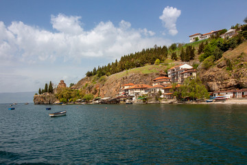 Fototapeta na wymiar A view from Ohrid Lake to Ohrid's Fishermen's Quarter with St. Kaneo's Church on a cliff. Northern Macedonia.