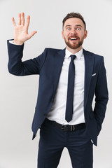 Happy young handsome businessman posing isolated