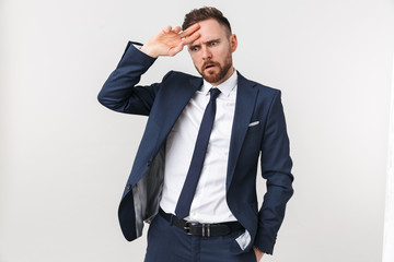 Confused businessman posing isolated over white wall background.