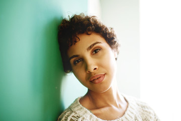 Close up attractive african american woman leaning against wall