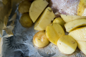 Raw chicken leg with potatoes ready to be cooked. Raw chicken with raw potatoes in the form for baking, ready to be cooked.