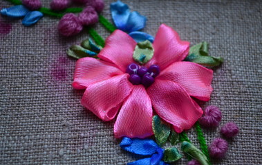 flowers embroidered with color satin ribbons on the fabric