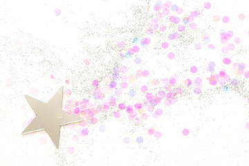 Confetti and silver stars on a white background, festive concept.