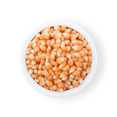 Dry corn seeds in bowl isolate on white background. Top view.