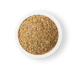 Pile of dried oregano leaves in bowl isolate on white background. top view
