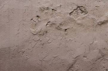 Abstract grunge texture - old battered wall with potholes.