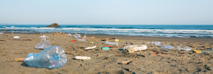 Dirty beach landscape full of waste without people
