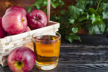 apples red Apple juice in a transparent glass on a natural background