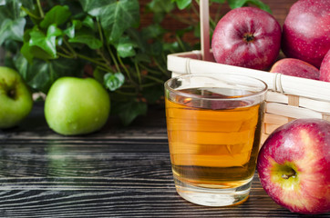 apples red and green Apple juice in a transparent glass on a natural background