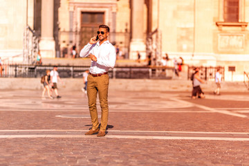A businessman on a square talking on his phone