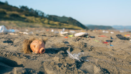 Dirty beach landscape full of waste without people