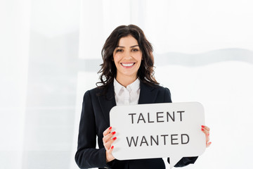 happy and beautiful recruiter holding speech bubble with talent wanted lettering