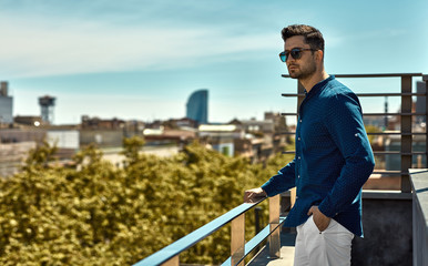 Handsome man in summer time looking on city view