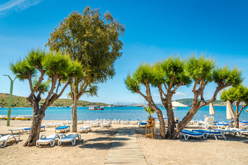 Beautiful exotic beach with deck chairs in Bodrum, Turkey