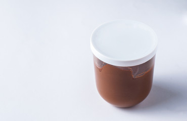 Tasty chocolate spread in jar isolated on white background