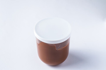 Tasty chocolate spread in jar isolated on white background