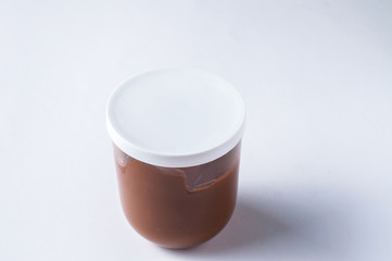 Tasty chocolate spread in jar isolated on white background