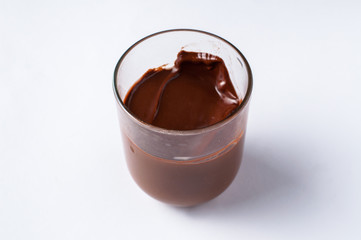 Tasty chocolate spread in jar isolated on white background