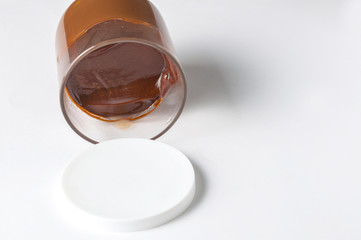 Tasty chocolate spread in jar isolated on white background