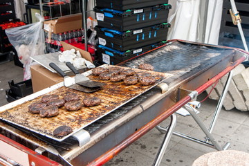 Cooking fast food burgers on the street