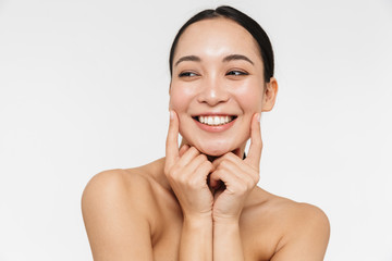 Asian woman posing naked isolated over white wall background.