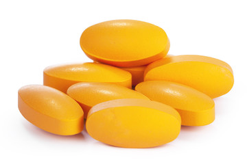 yellow vitamin pills isolated on white background