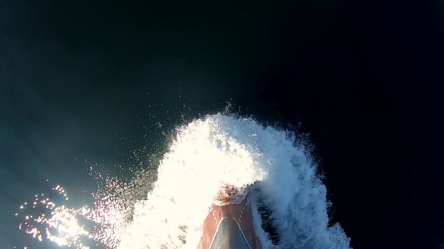 the bow of the ship cuts through the waves