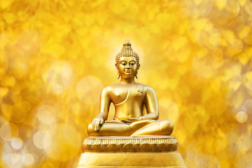 Beautiful of Golden Buddha statue on golden yellow bokeh leaf Pho leaf (Bo leaf) background.