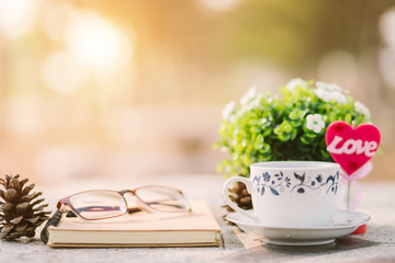 Close-up of empty notebook,spectacles and cup of coffee on Marble floor background. Love concept with heart desktop,Valentine's Day.