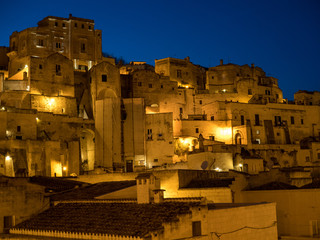 Fototapeta premium Italy - April, 2019: Amazing lighted buildings in ancient Sassi center by night in Sassi di Matera