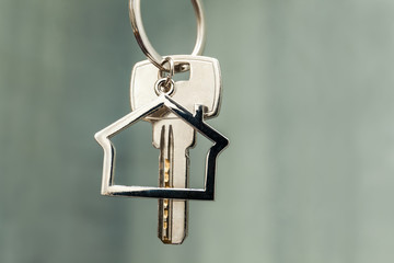 House key with house figure on the background