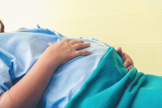 Pregnant woman lying on the bed waiting to give birth in a hospital.