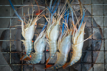 Thai people cooking grill shrimp on stove retro Thai style