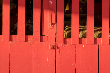 The pattern of the red wooden door.