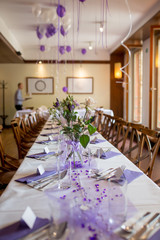 Elegant table setup in purple pastels for a restaurant wedding