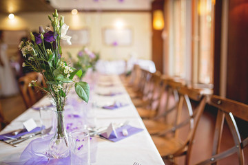 Elegant table setup in purple pastels for a restaurant wedding