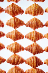 Rhombus french croissants pattern on a light background.