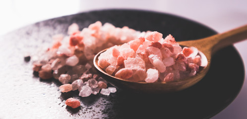 Fototapeta na wymiar Pink salt from Bolivian in spoon on ceramic plate