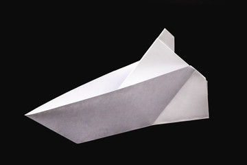 paper boat isolated on black background, handmade paper origami.
