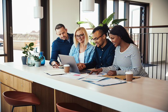 Diverse businesspeople working on a laptop in an office