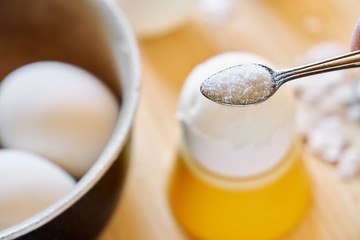 Putting a salt on the boiled chicken egg during breakfast