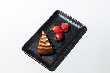 Homemade cheese cake and strawberry on plate. White background