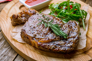 Fototapeta juicy Ribeye steak on wooden background obraz